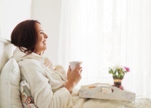 woman relaxing breakfast bed