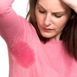 Woman sweating very badly under armpit