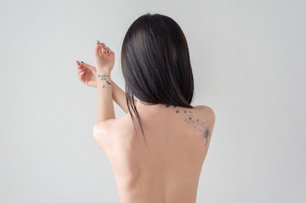 the back of a girl with a tattoo