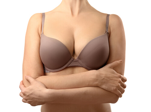 young lady in a bra crossing her arms