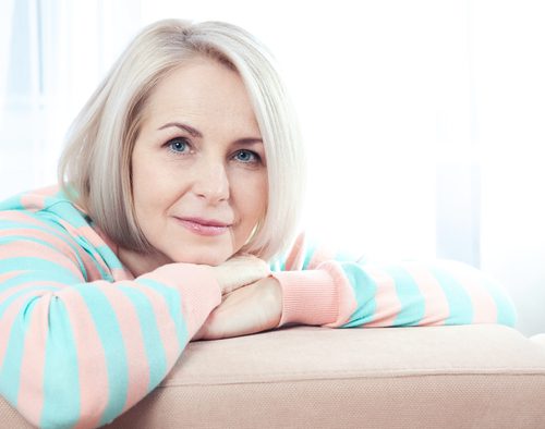 active beautiful middle-aged woman smiling friendly and looking into the camera at home-img-blog