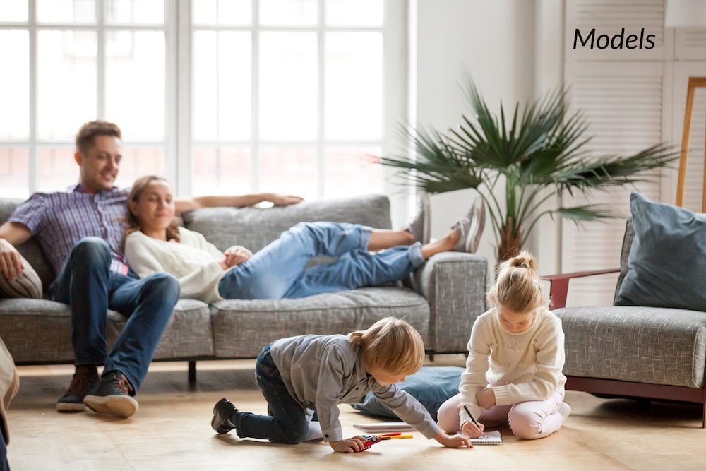 Woman relaxing on couch surrounded by her family after plastic surgery.