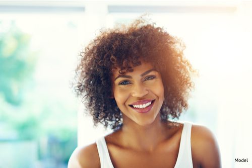 woman smiling after choosing the right facial rejuvenation technique for her.