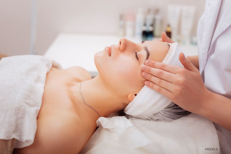  A woman being prepared for skin treatment.