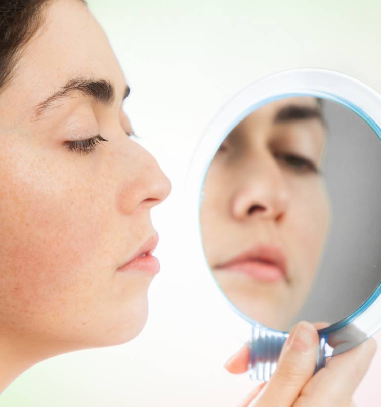 Woman looking in a mirror