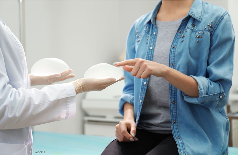 A woman choosing her breast implant type.