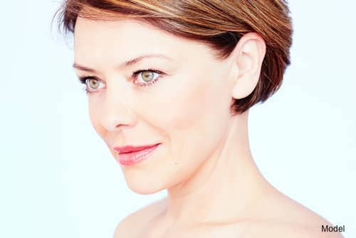 Middle-aged woman with brown hair smiling