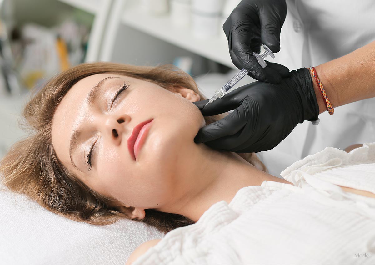 Woman getting injectable treatment in her jaw