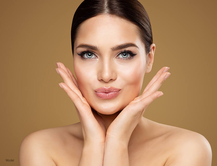 Woman framing her face with her hands