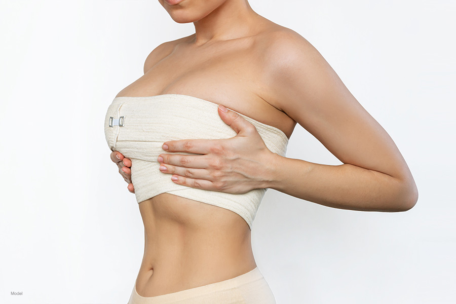 Young woman with her breast bandaged