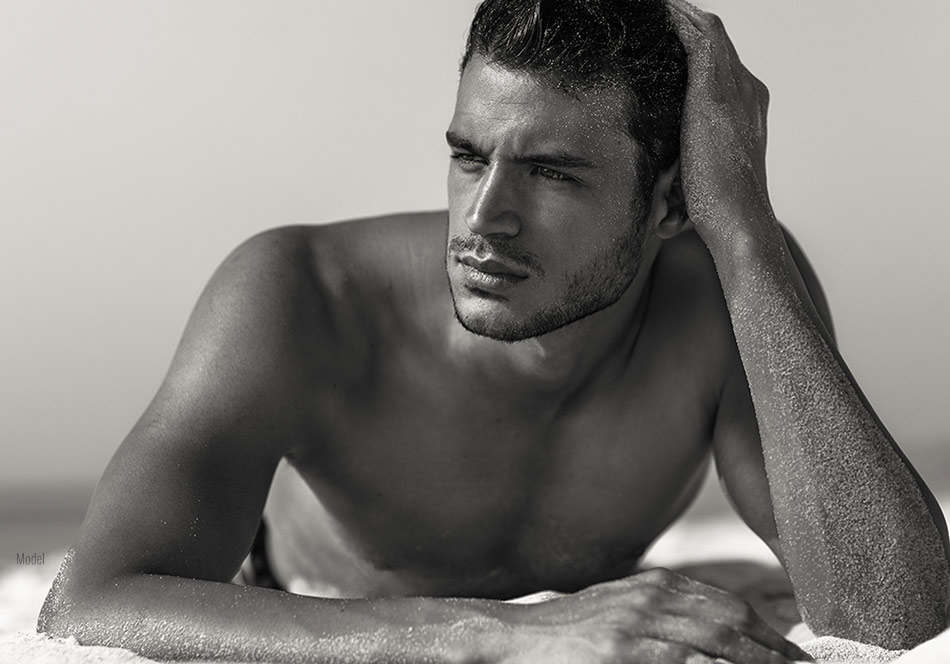 Male model on the beach over in sand