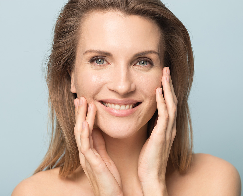 A happy woman touching her cheek with both hands